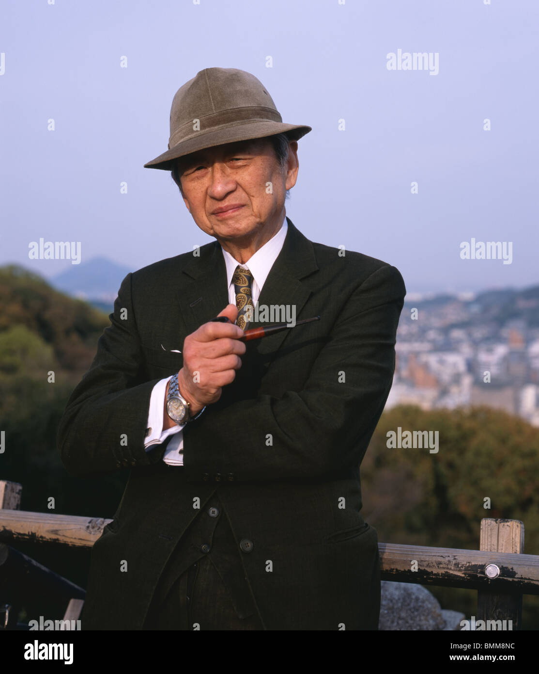 Elderly Japanese man smoking pipe, Matsuyama City, Japan Stock Photo