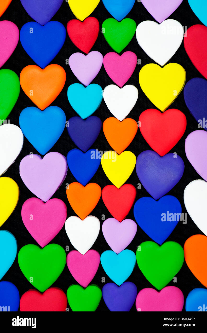 Multicoloured heart shape pattern against black background Stock Photo