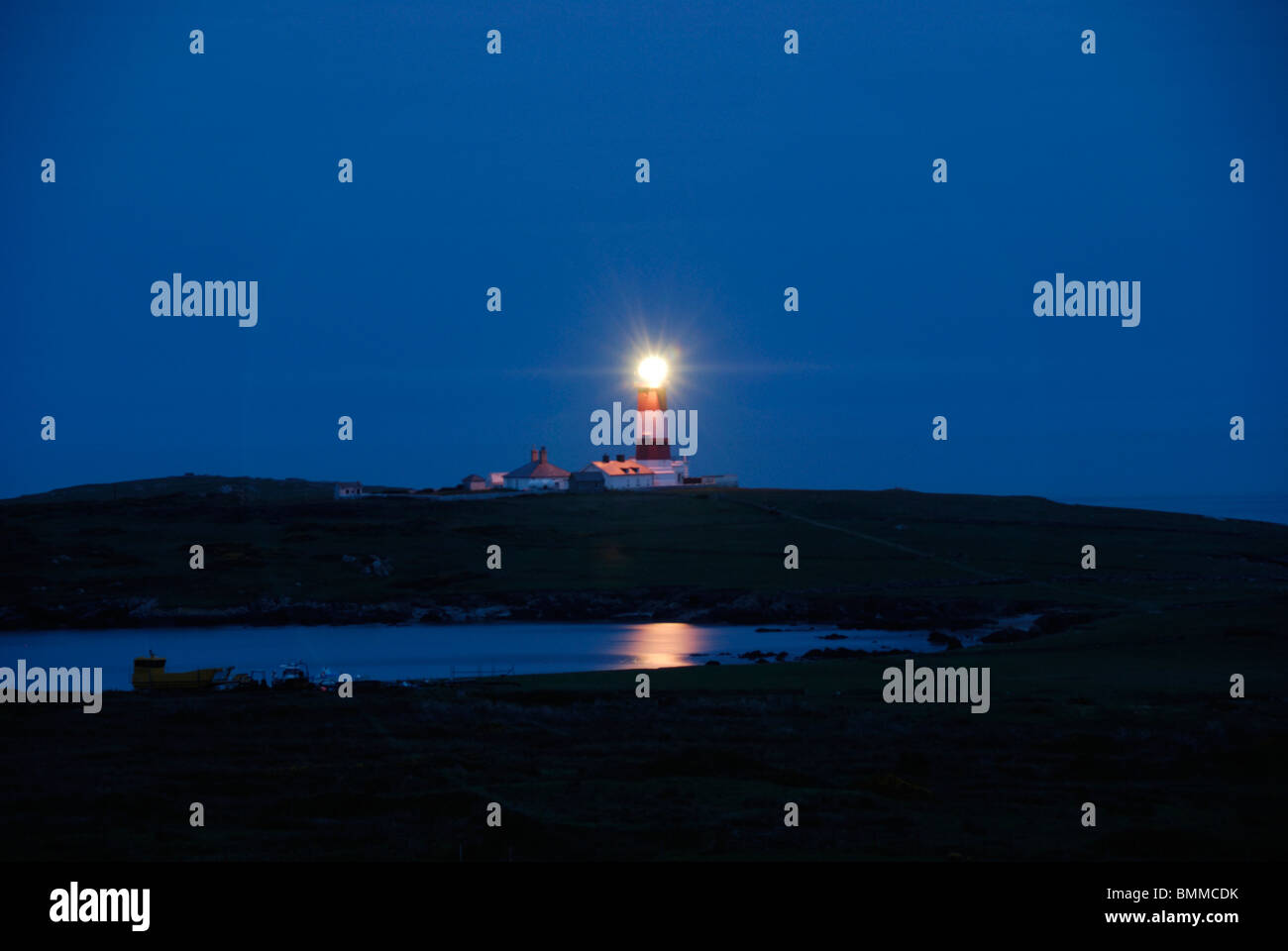 Lighthouse on Bardsey Island in the evening Stock Photo