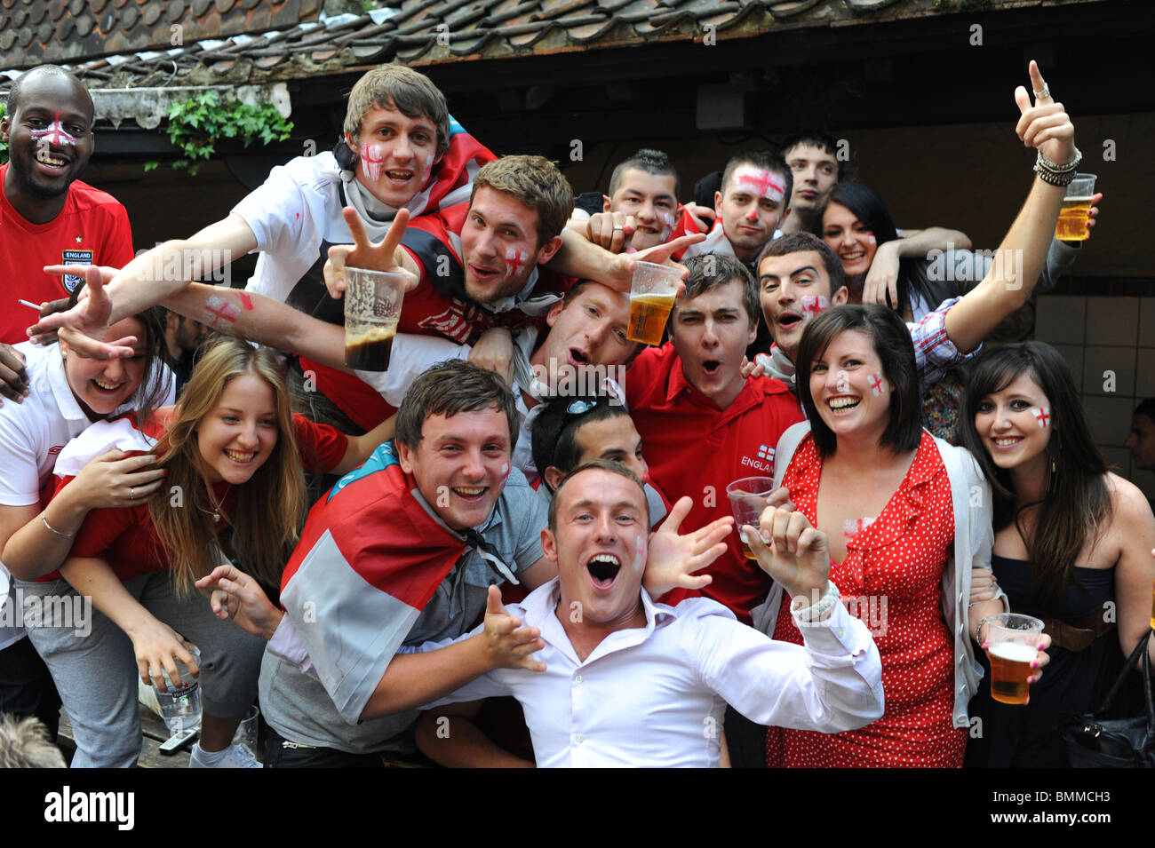 England football fans drinking beer and cheering at a pub in Brighton during the World Cup 2010 Stock Photo