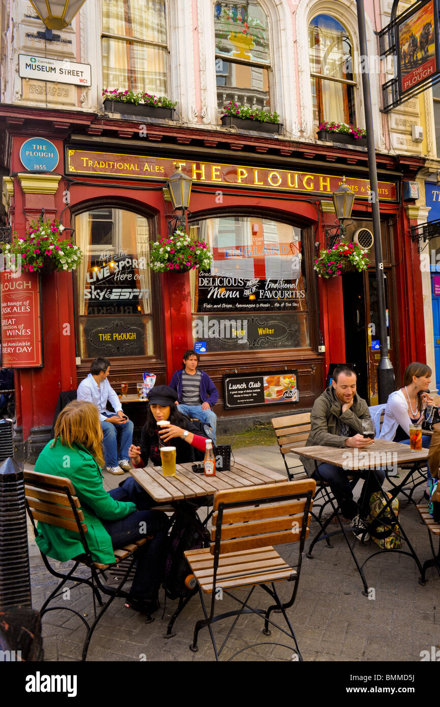 People Sharing Drinks on Terrace, at Old British Pubs, Bars, London