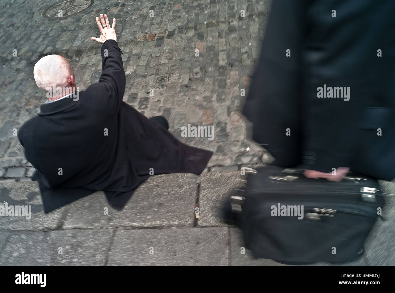 Drunk man sitting on the side of the road in Templebar Dublin Ireland Stock Photo