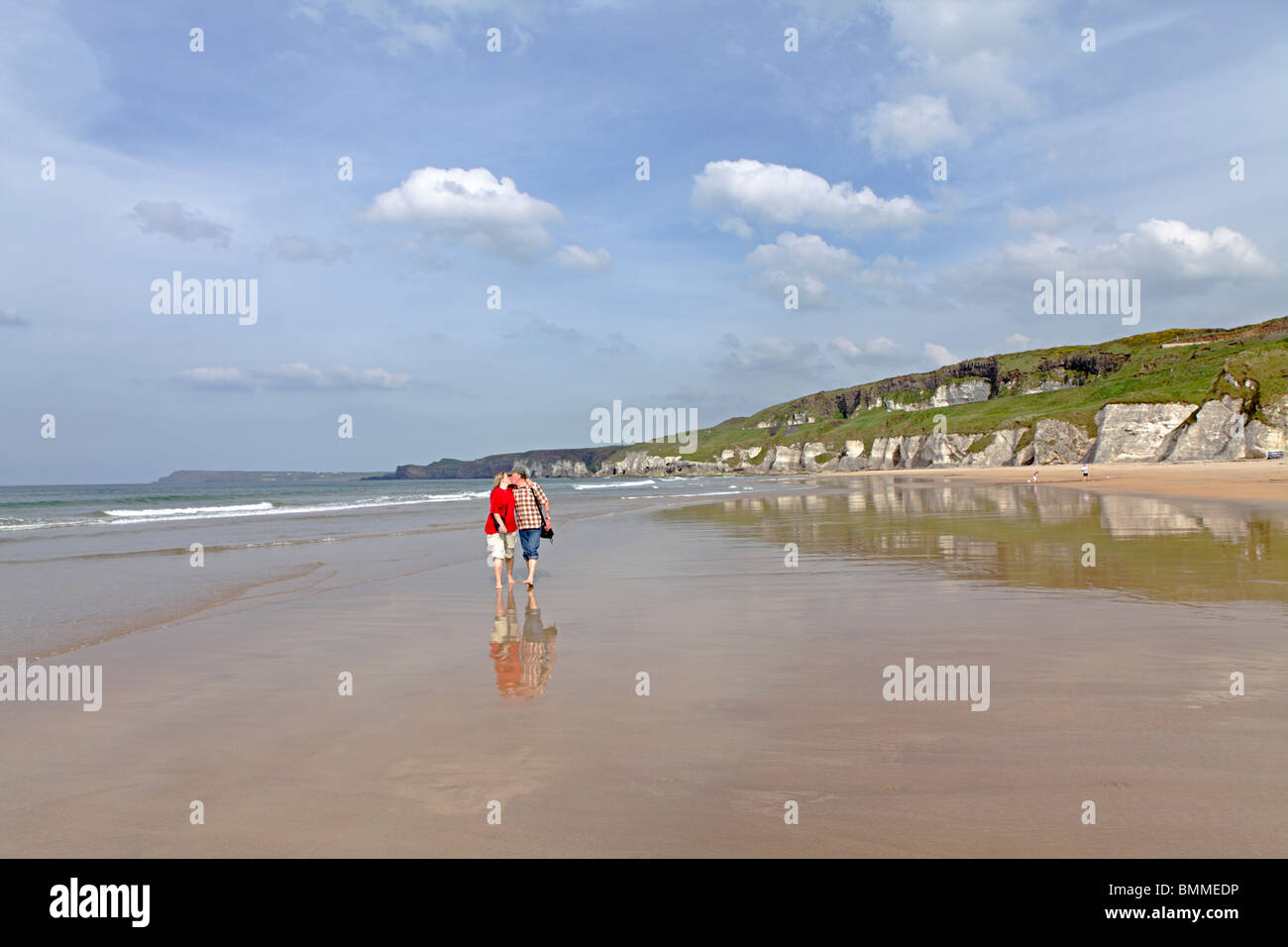 couple at a sandy beach near Portrush, Co. Antrim, Northern Ireland Stock Photo