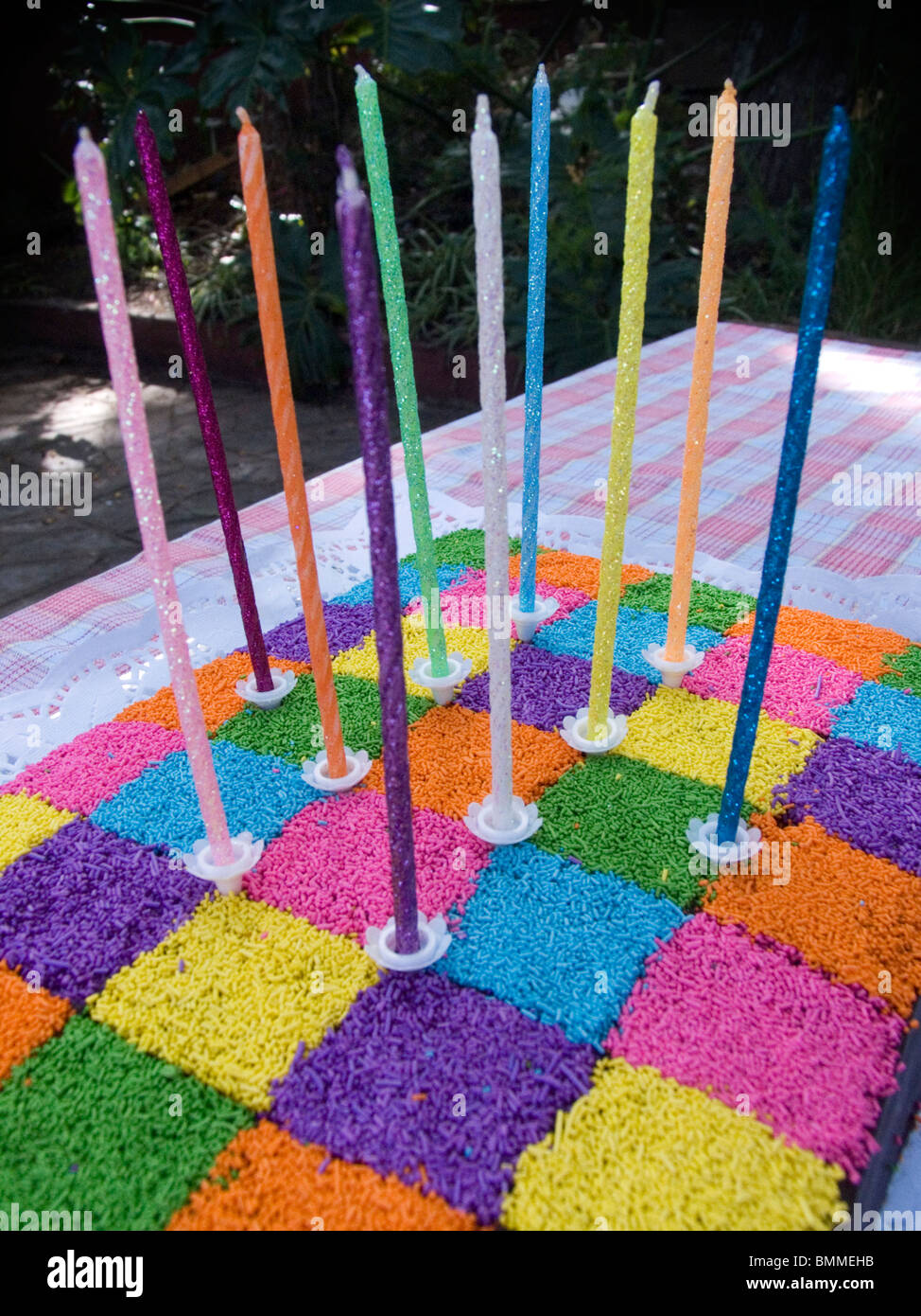 A colorful birthday cake with tall candles Stock Photo Alamy