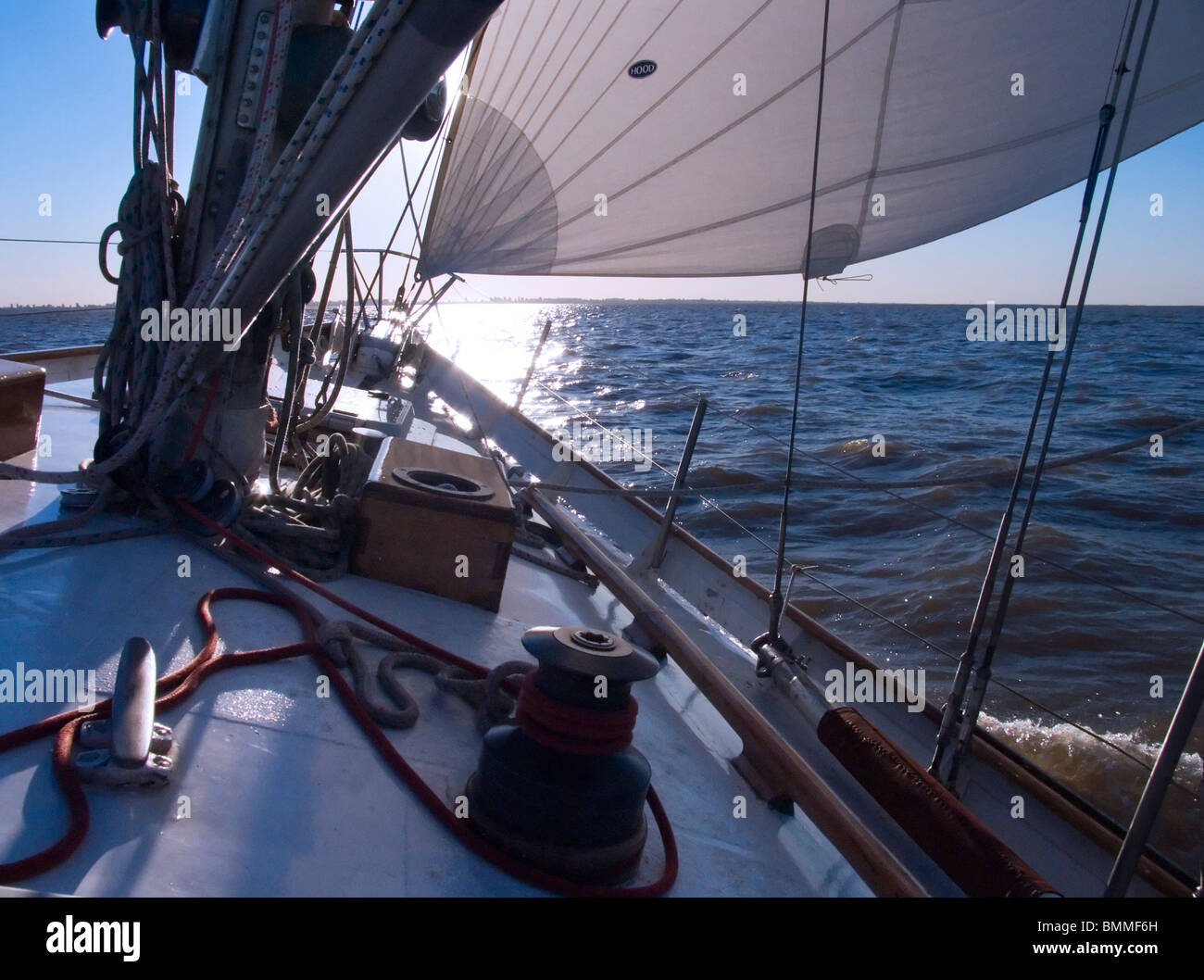 sun setting Scene behind the sails aboard the deck of two mast sail