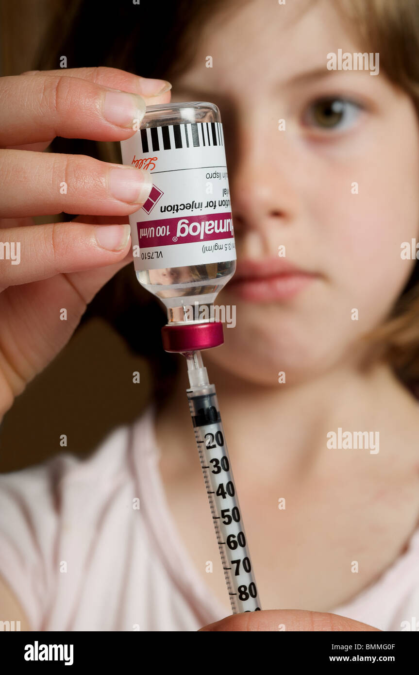 Young girl drawing up insulin injection Stock Photo