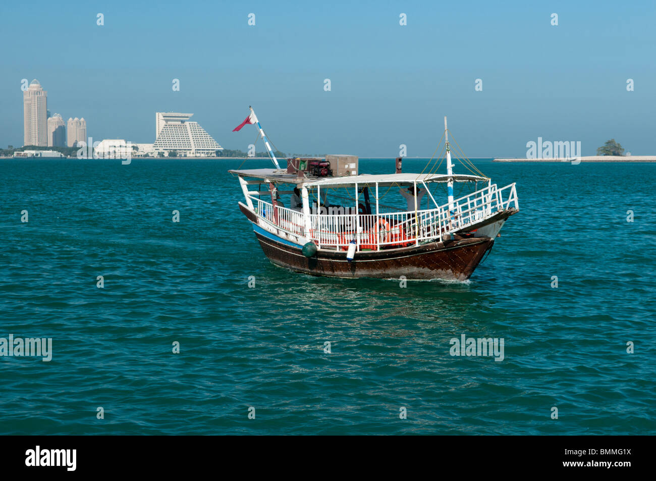 Dhow (boat) in Doha, Qatar with Qtel Tower and Sheraton Hotel in background Stock Photo