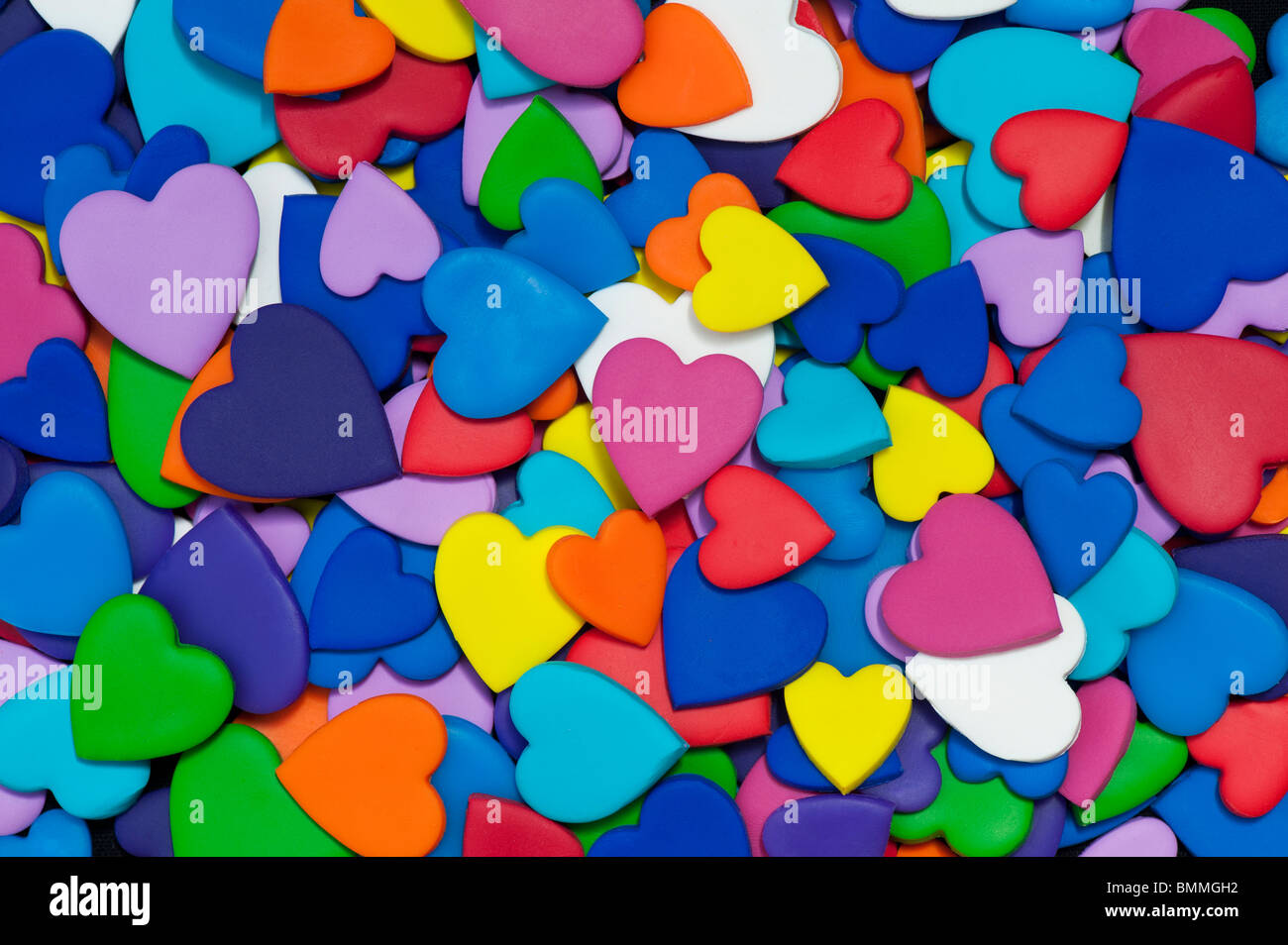 Multicoloured heart shape pattern against black background Stock Photo