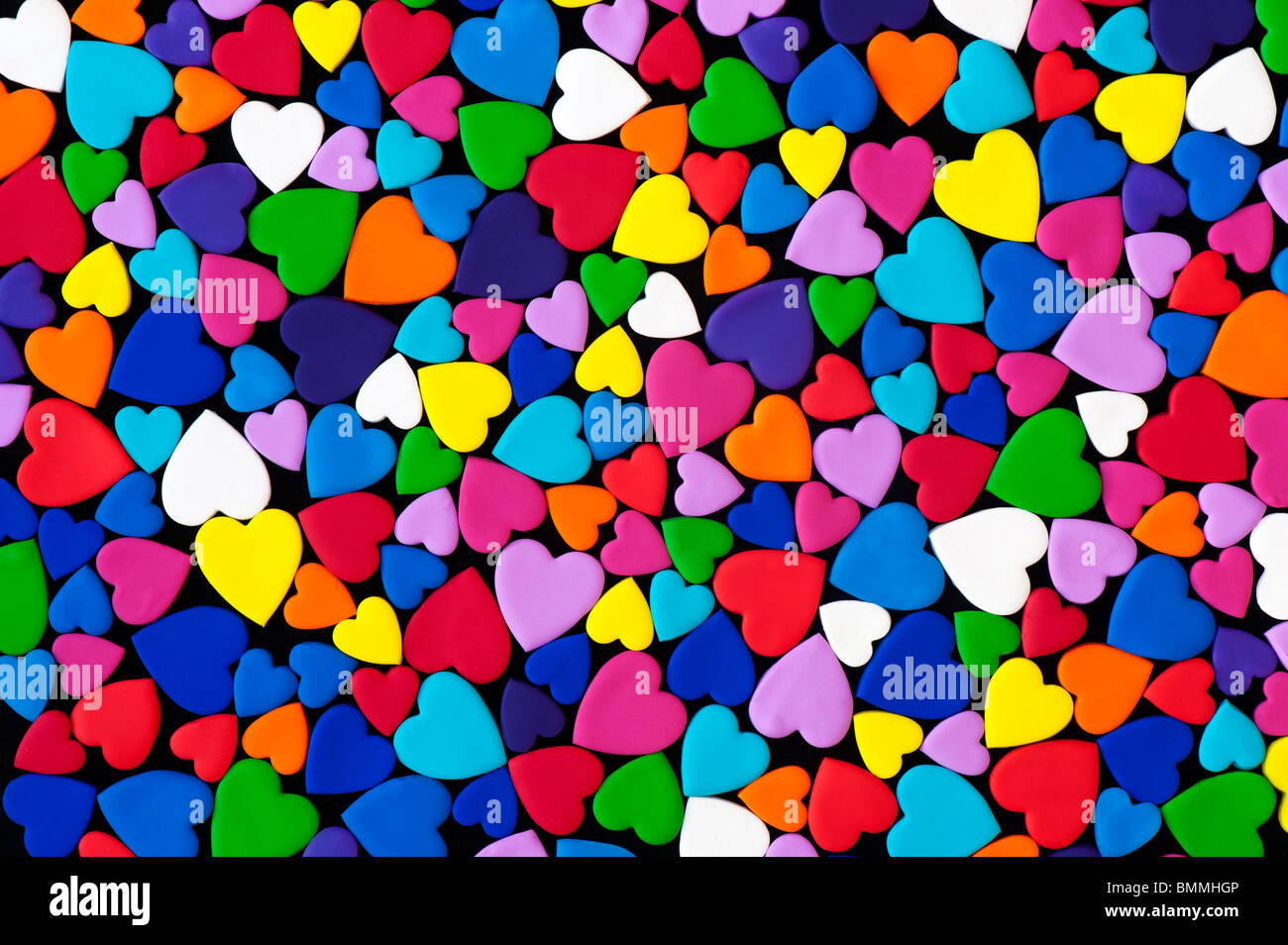 Multicoloured heart shape pattern against black background Stock Photo