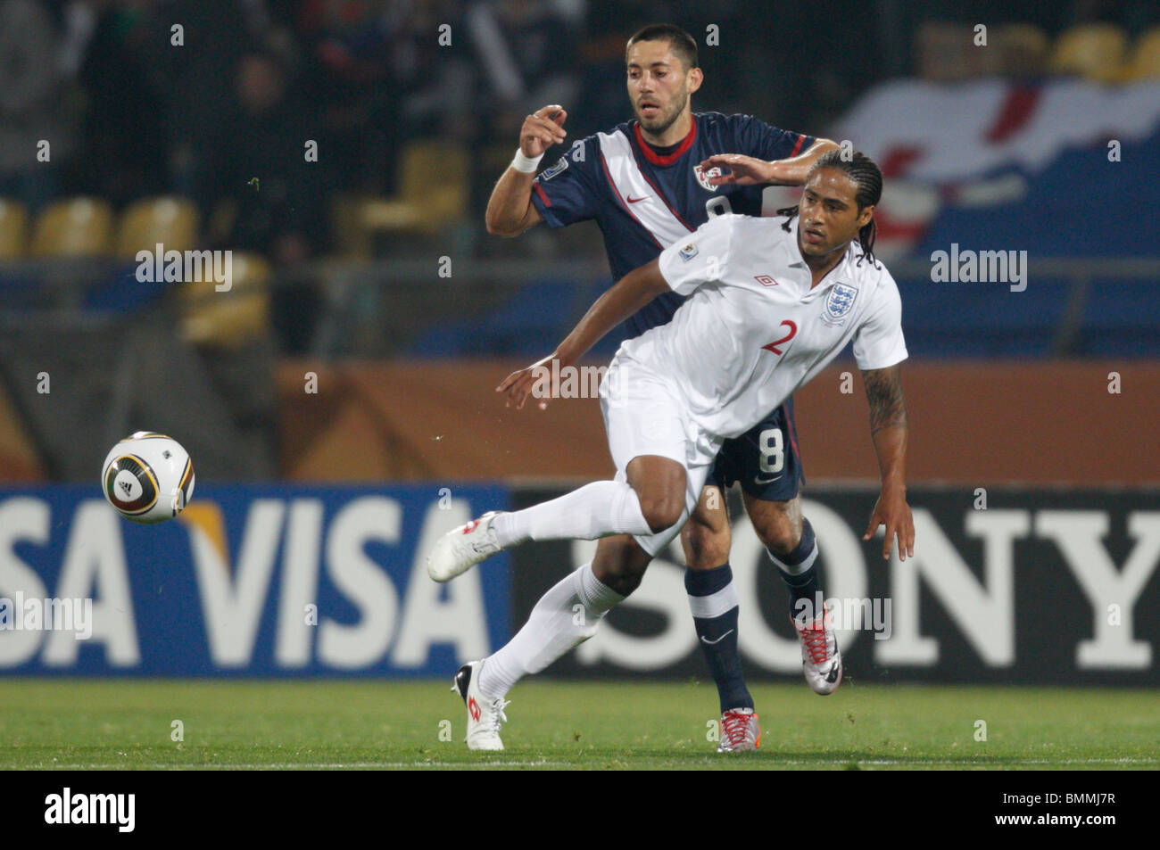 Clint Dempsey of the United States (8) and Glen Johnson of England (2) eye the ball during a 2010 FIFA World Cup football match. Stock Photo