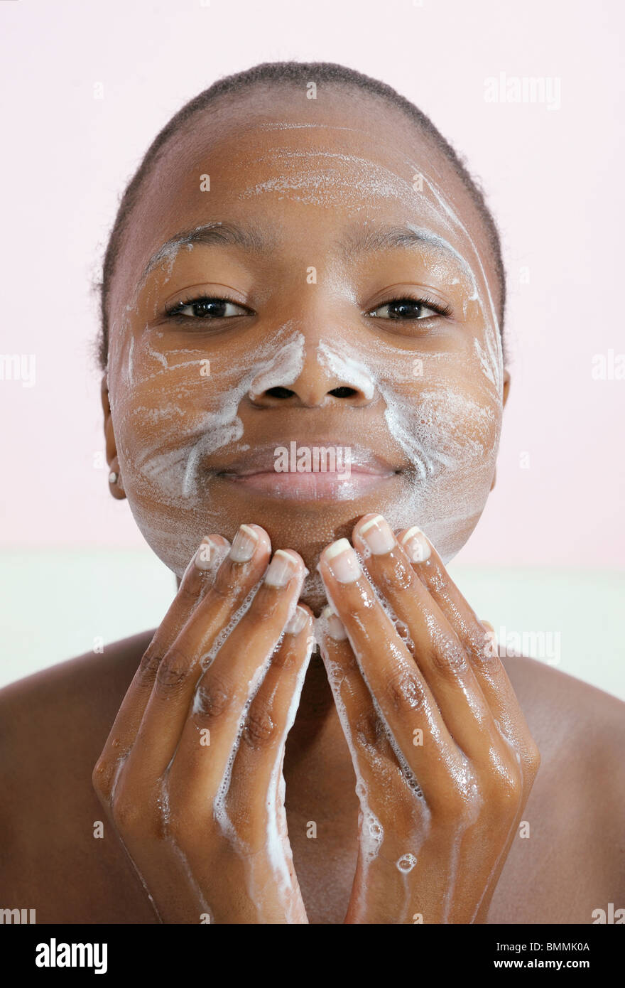 Teenage girl washing face, Cape Town, Western Cape Province, South Africa Stock Photo