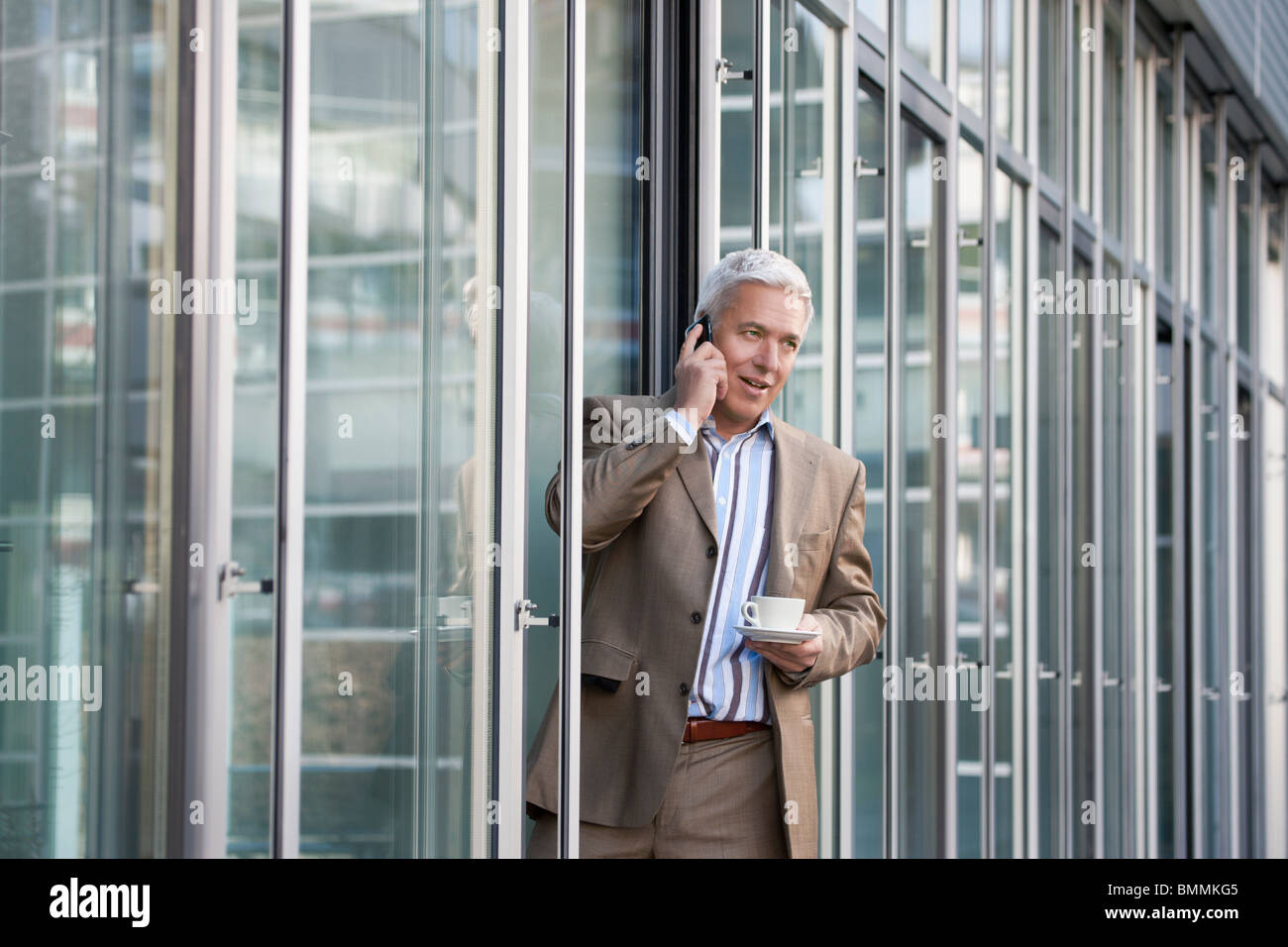 On the phone during the coffee break Stock Photo