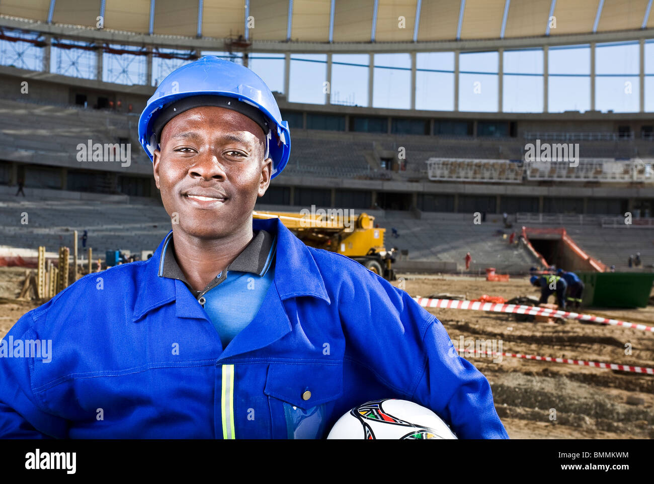 Construction worker with football , Moses Mabhida Stadium, Durban, Kwazulu-Natal Province, South Africa Stock Photo