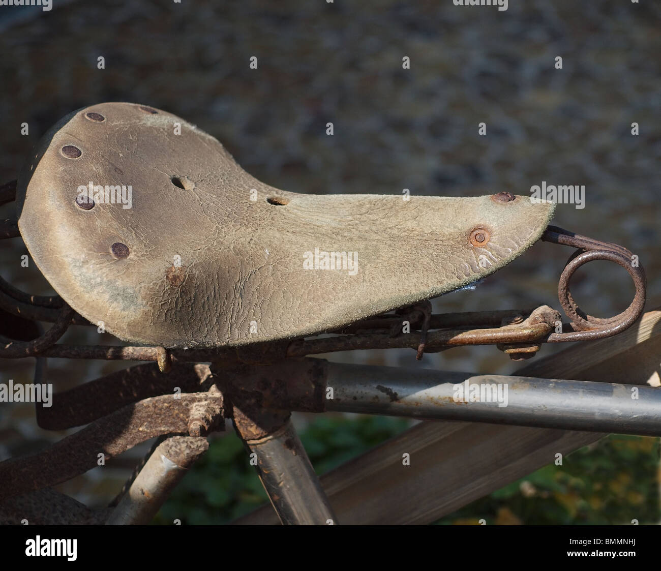 Vintage leather bike saddle with metal spring suspension Stock Photo
