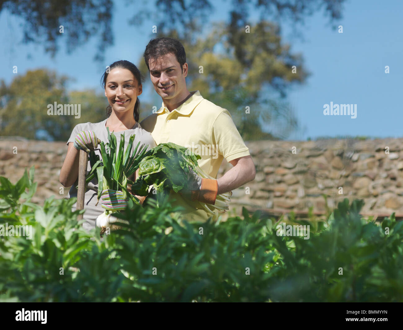 Man and woman with freshly picked vegs Stock Photo - Alamy