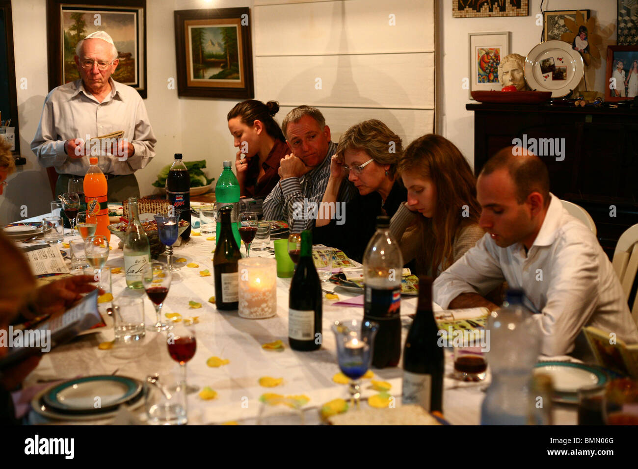 family sitting around a table set for a Jewish Festive meal on Passover