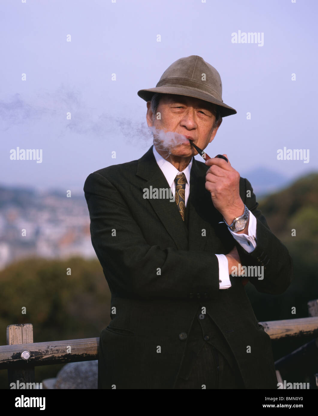 Elderly Japanese man smoking pipe, Matsuyama City, Japan Stock Photo