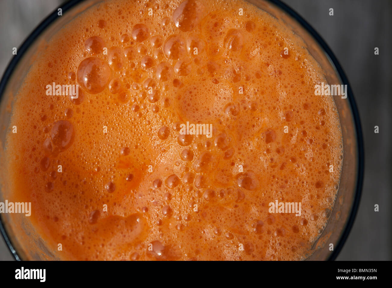 A glass of freshly squeezed carrot and apple juice seen from above. Stock Photo