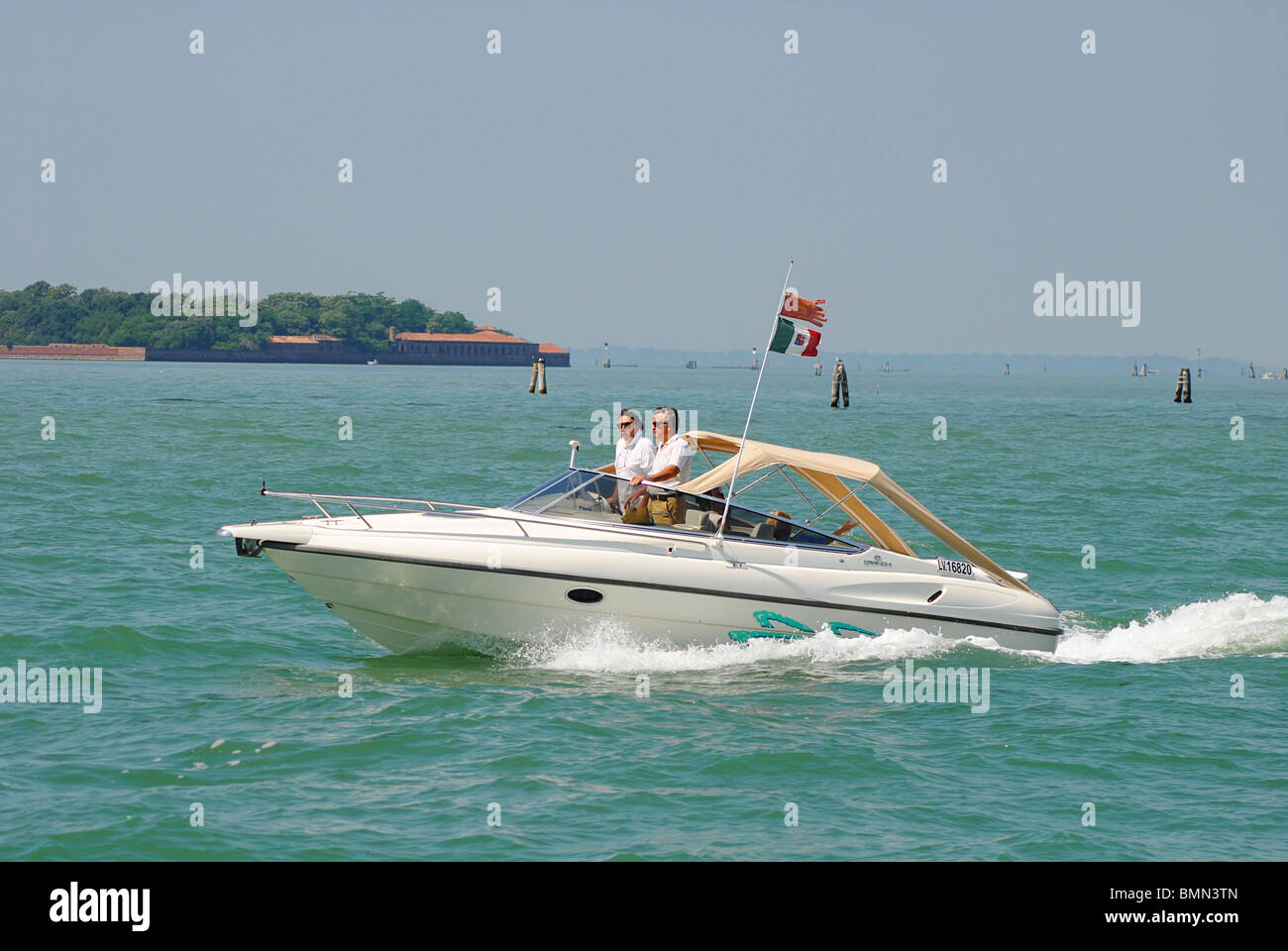 Two Italian men in a speed boat on the Venetian lagoon Stock Photo