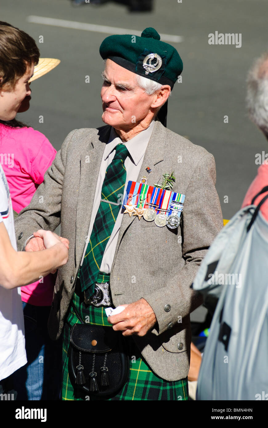 Old and young: elderly war veteran and grandson, after the ANZAC Day parade in Sydney, Australia. Stock Photo