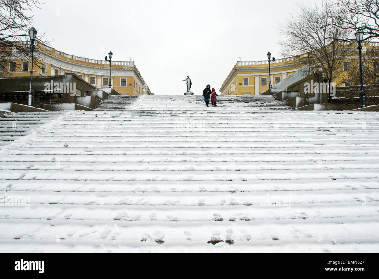 People carefully walking downstairs on a staircase full of snow in Odessa. Ukranie, Europe Stock Photo
