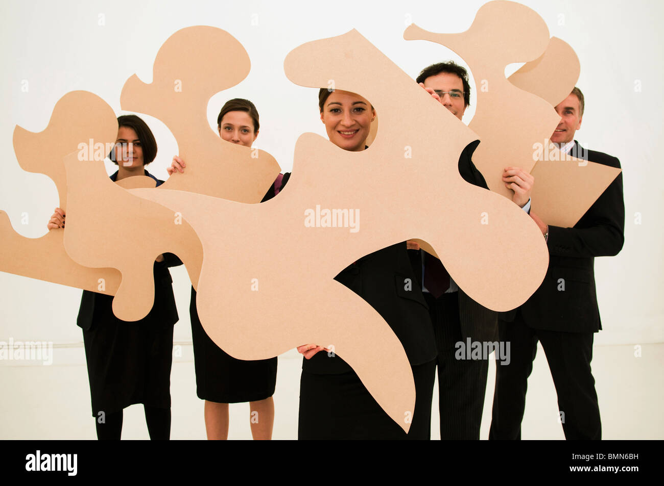 Group of business people hold jigsaw Stock Photo