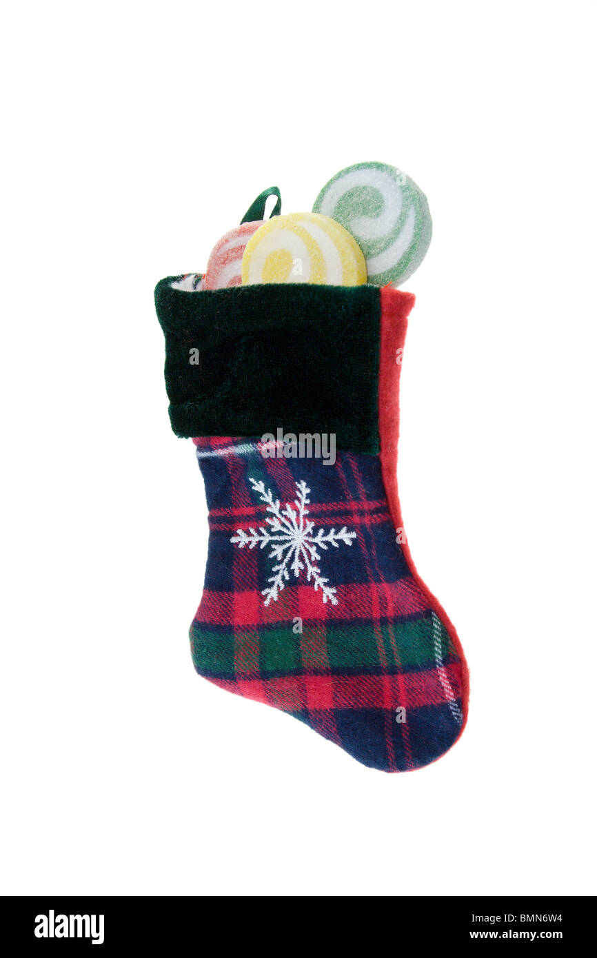 red, green, and blue plaid Christmas stocking with swirl lollipops on white with copyspace Stock Photo