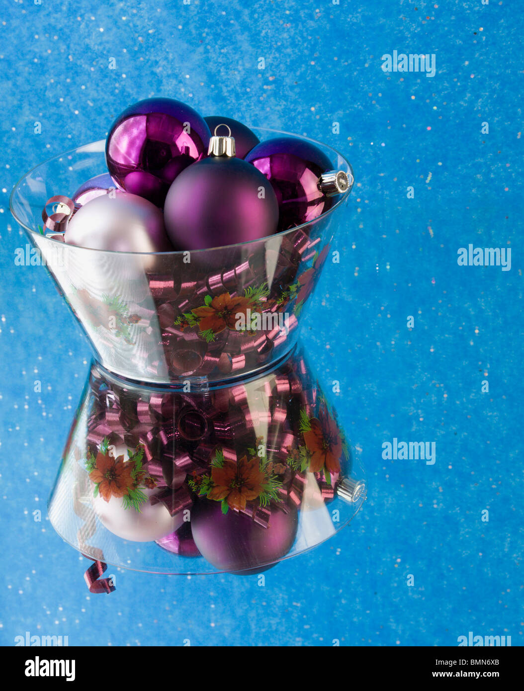 various purple Christmas ornaments in a bowl with copyspace Stock Photo