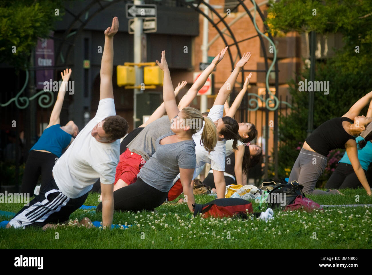 Yoga practitioners participate in a free yoga class in the New York neighborhood of Chelsea Stock Photo