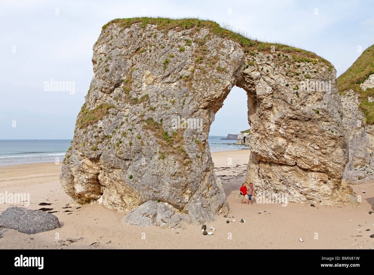 natural archway at a sandy beach near Portrush, Co. Antrim, Northern Ireland Stock Photo