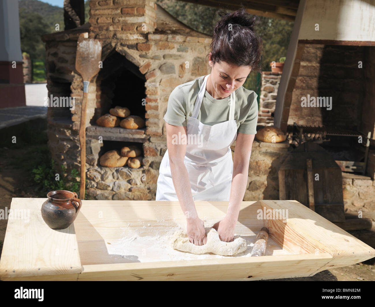 Woman kneading bread dough Stock Photo