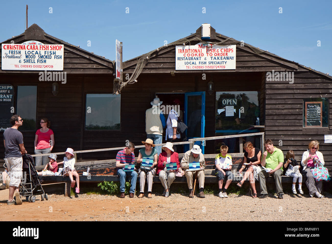 People enjoying fish and chips in Southwold Suffolk Stock Photo Alamy