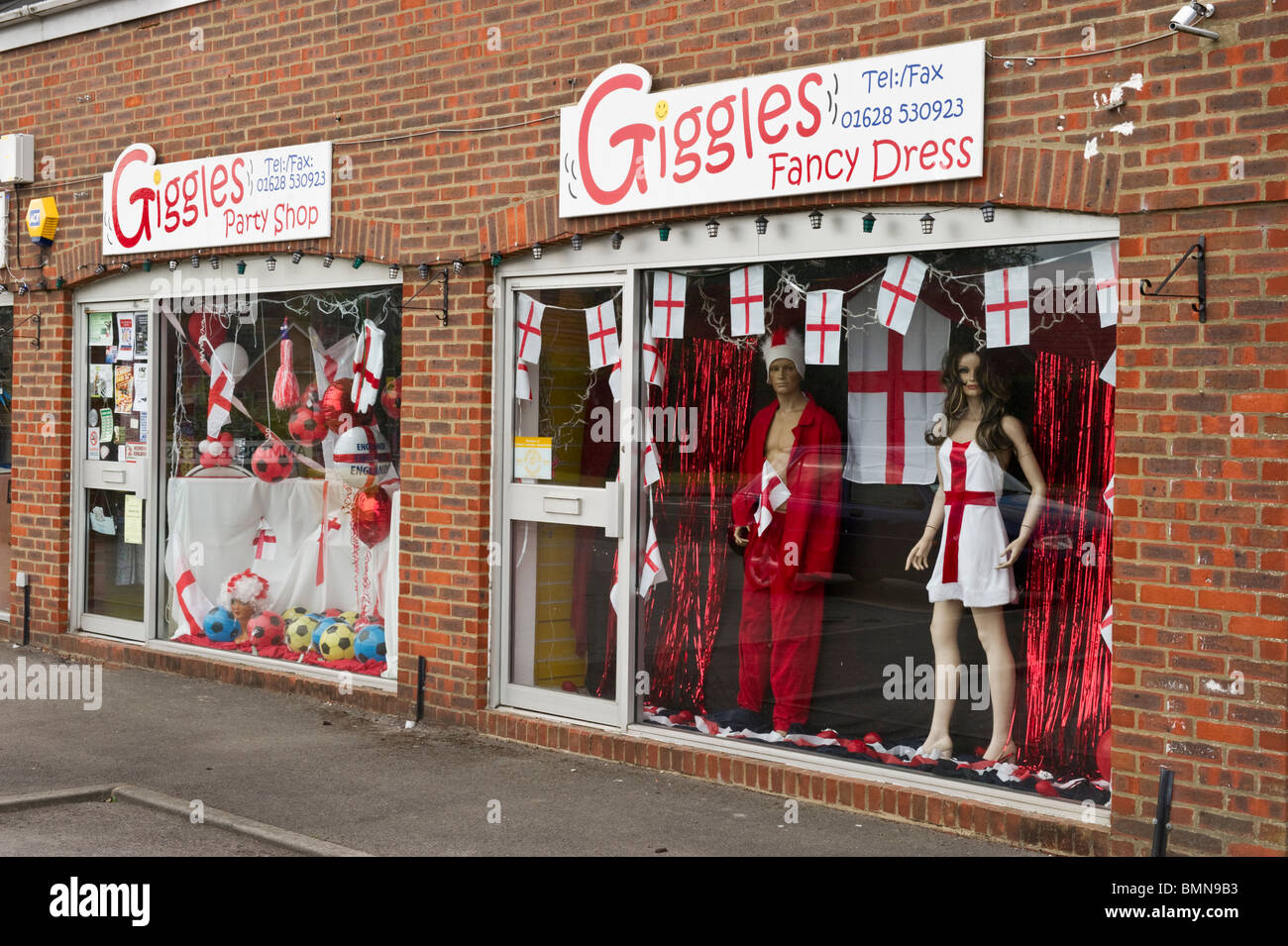 A fancy dress shop window display with English flags and World Cup football memorabilia souvenirs 2010 Stock Photo