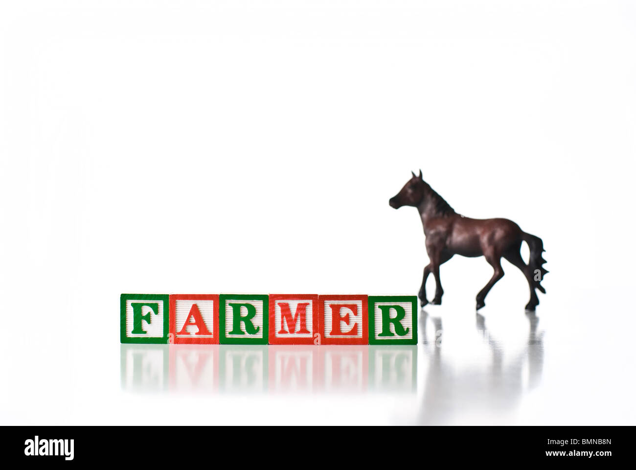 Colorful children's blocks spelling FARMER with a horse Stock Photo