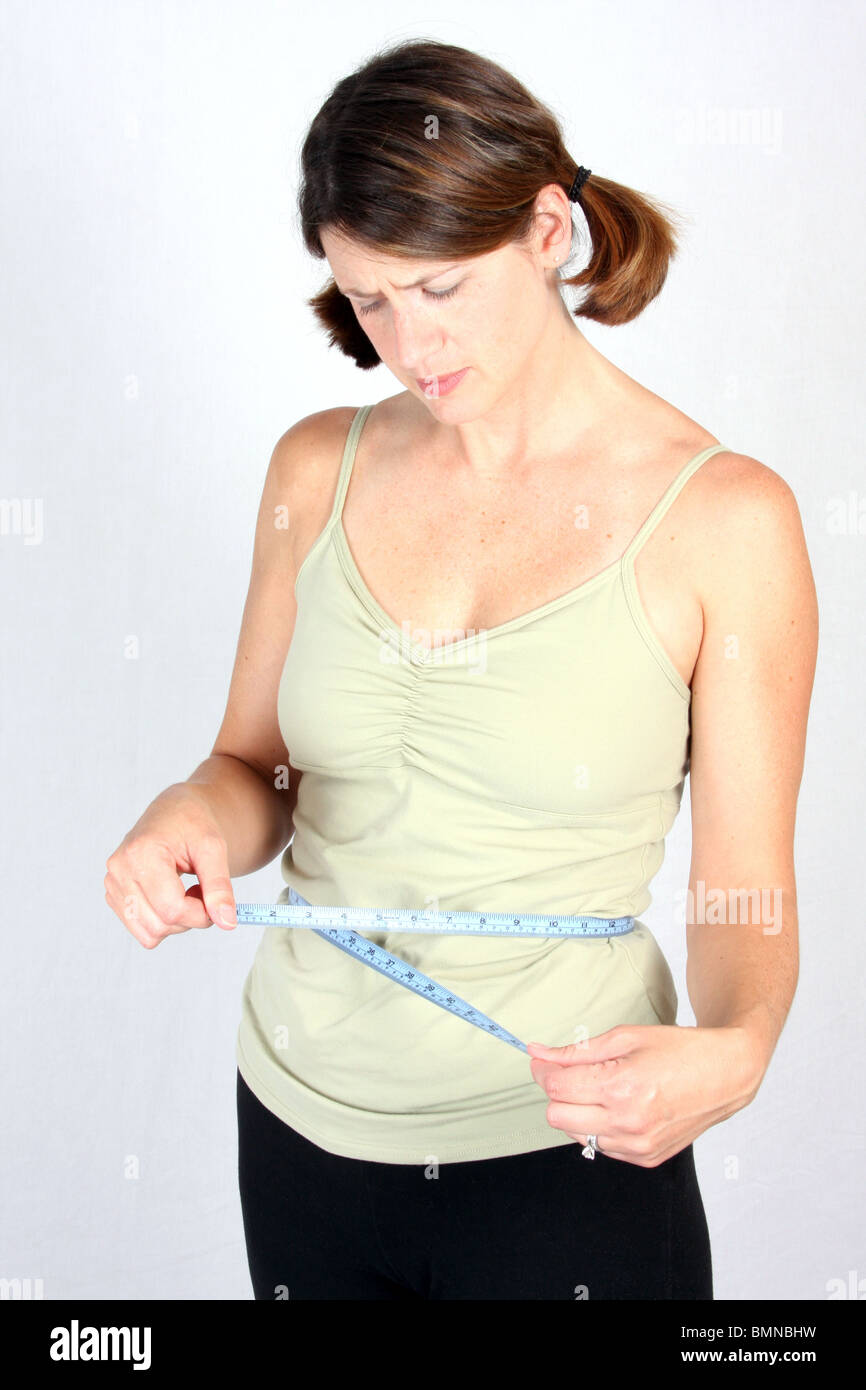 Overweight woman with tape measure around waist. Stock Photo by ©flisakd  179142730