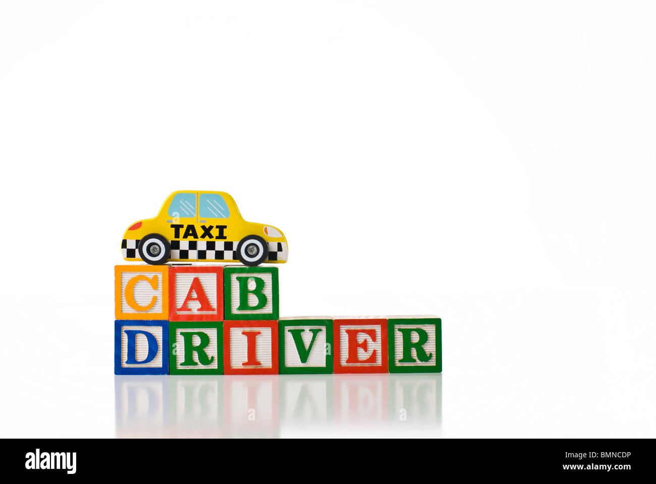 Colorful children's blocks spelling CAB DRIVER with a toy taxi cab