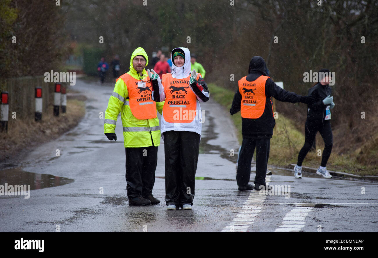 marshaling road running race in pouring rain Stock Photo