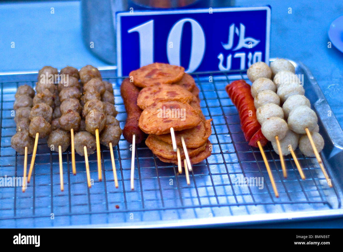 Variety of meats on skewers for sale on street in Bangkok, Thailand