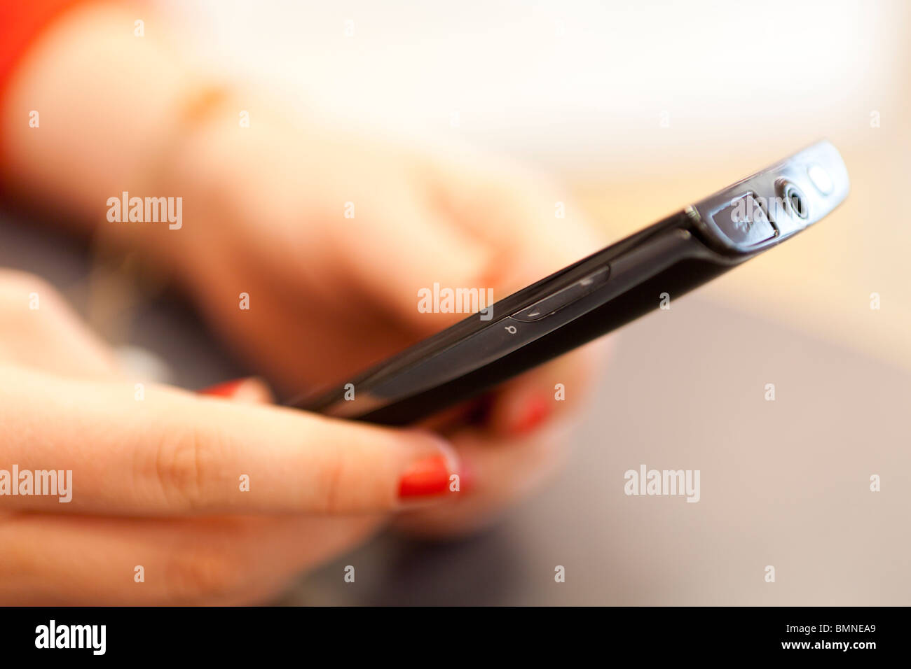 Person using a touch screen phone-side view,close-up Stock Photo