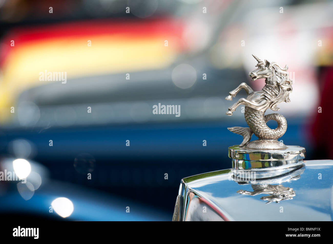 Unicorn fish tail hood ornament on a classic vintage car. UK Stock Photo