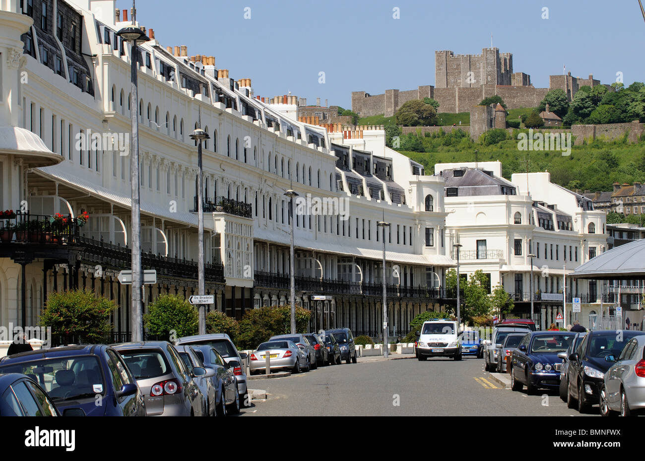 Terraced homes along Marine Parade overlooked by Dover Castle Kent England UK Stock Photo