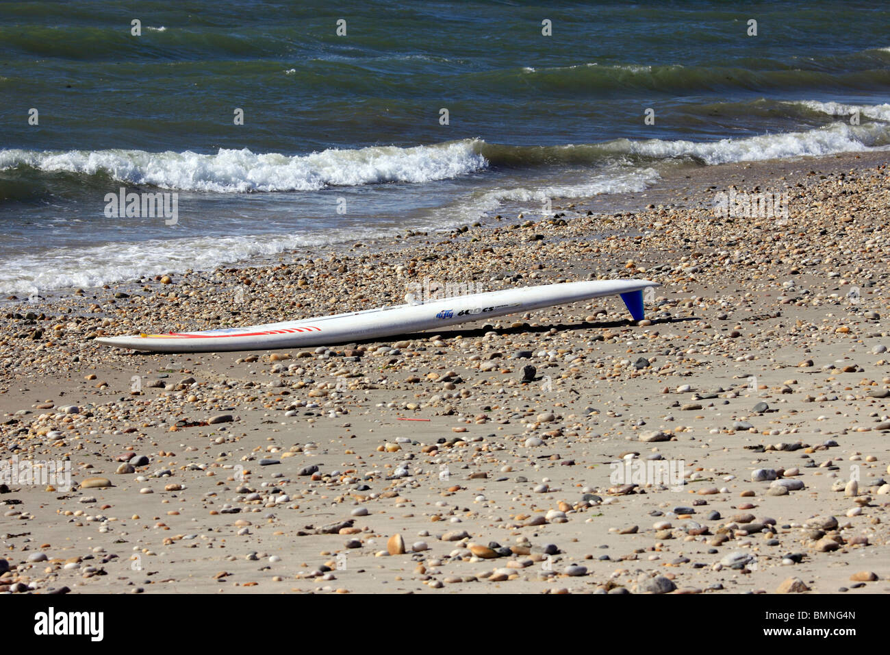 Surf board on beach, Long Island, NY Stock Photo