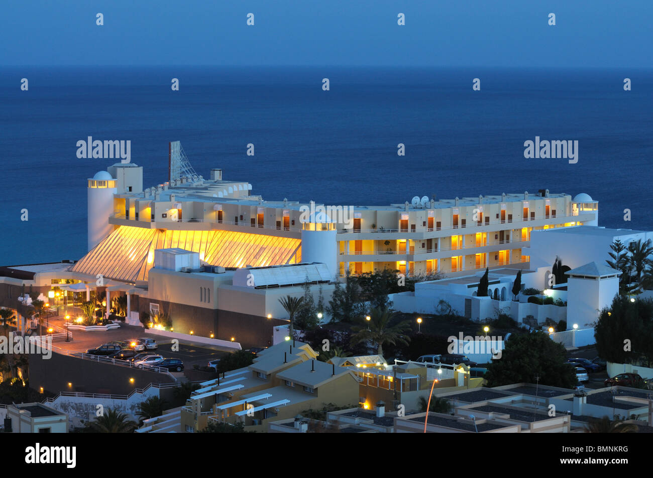 Hotel building at the coast illuminated at night Stock Photo