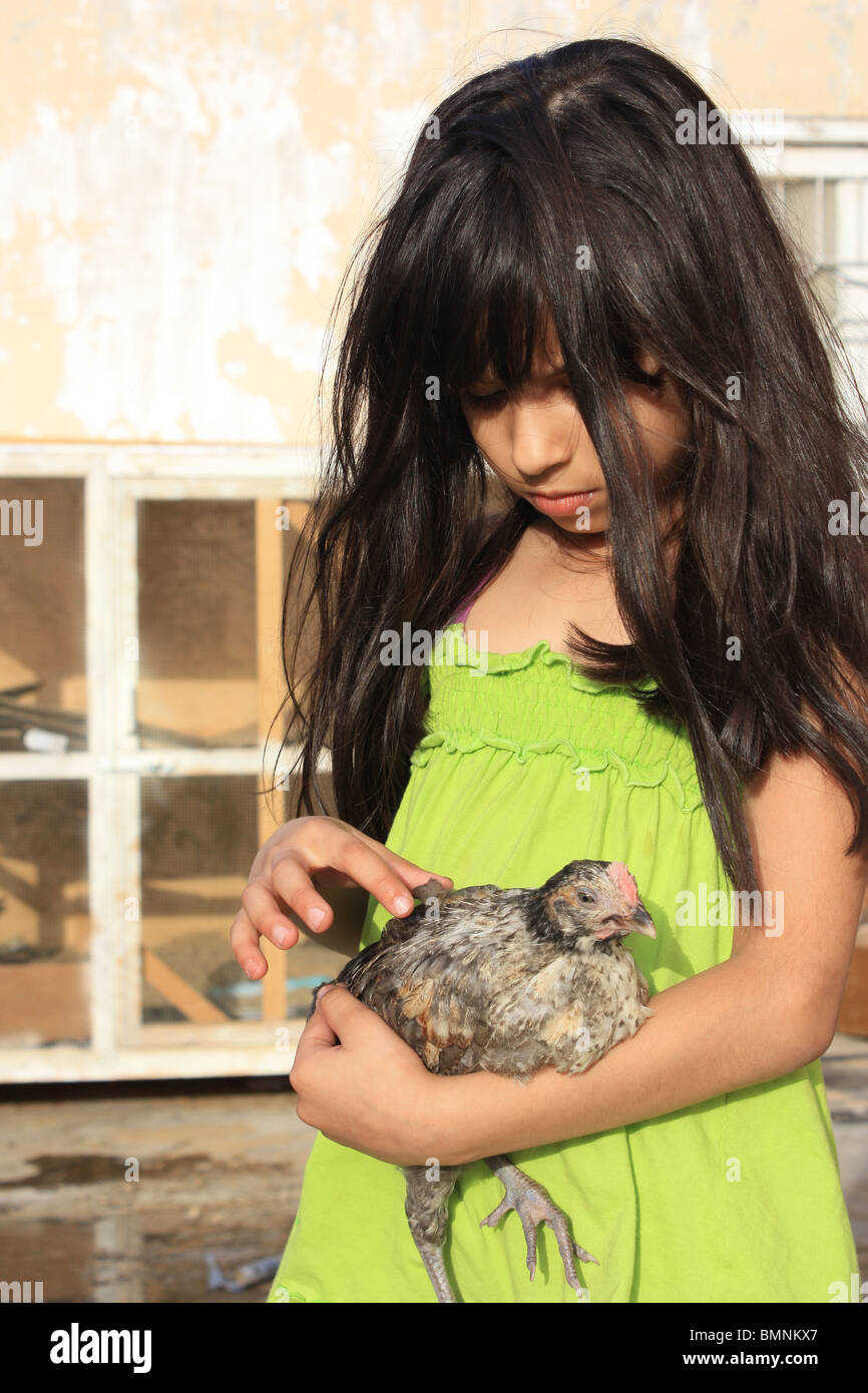 A Little Girl Is Holding A Small Chick Stock Photo