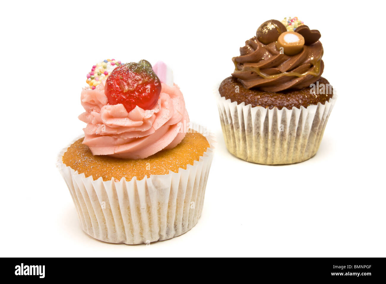 Luxury Strawberry and Chocolate Cup Cakes from low perspective isolated against white background. Stock Photo