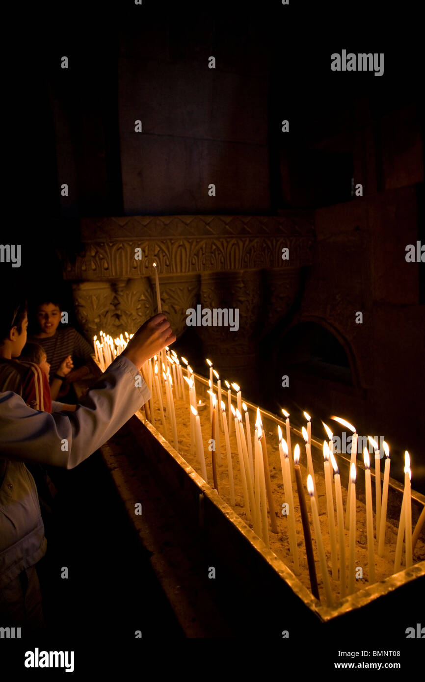 Lighting candles at church of The Holy Sepulchre in Jerusalem Stock