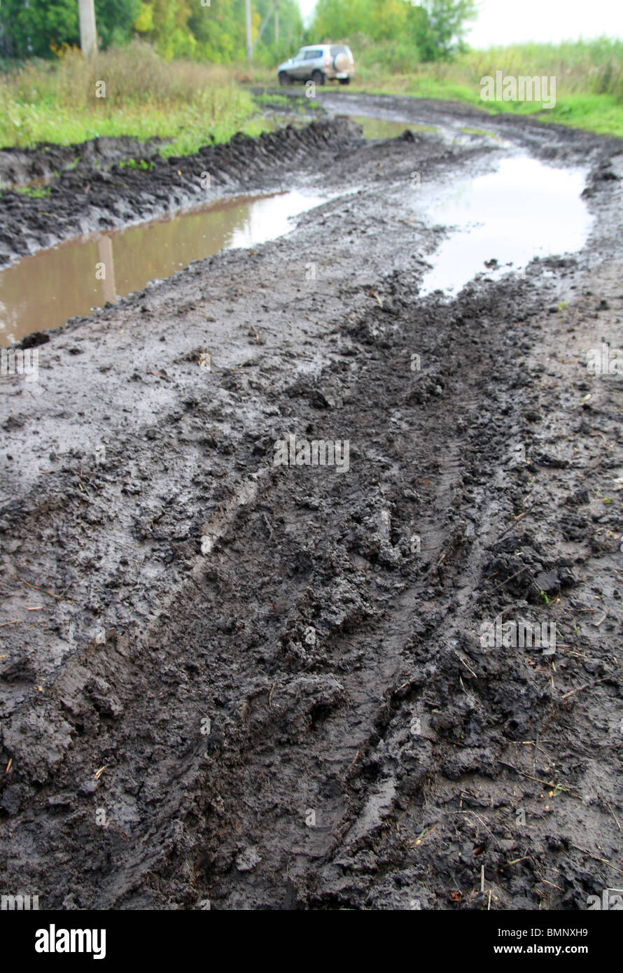 mud dirty road with deep tracks and puddle Stock Photo - Alamy