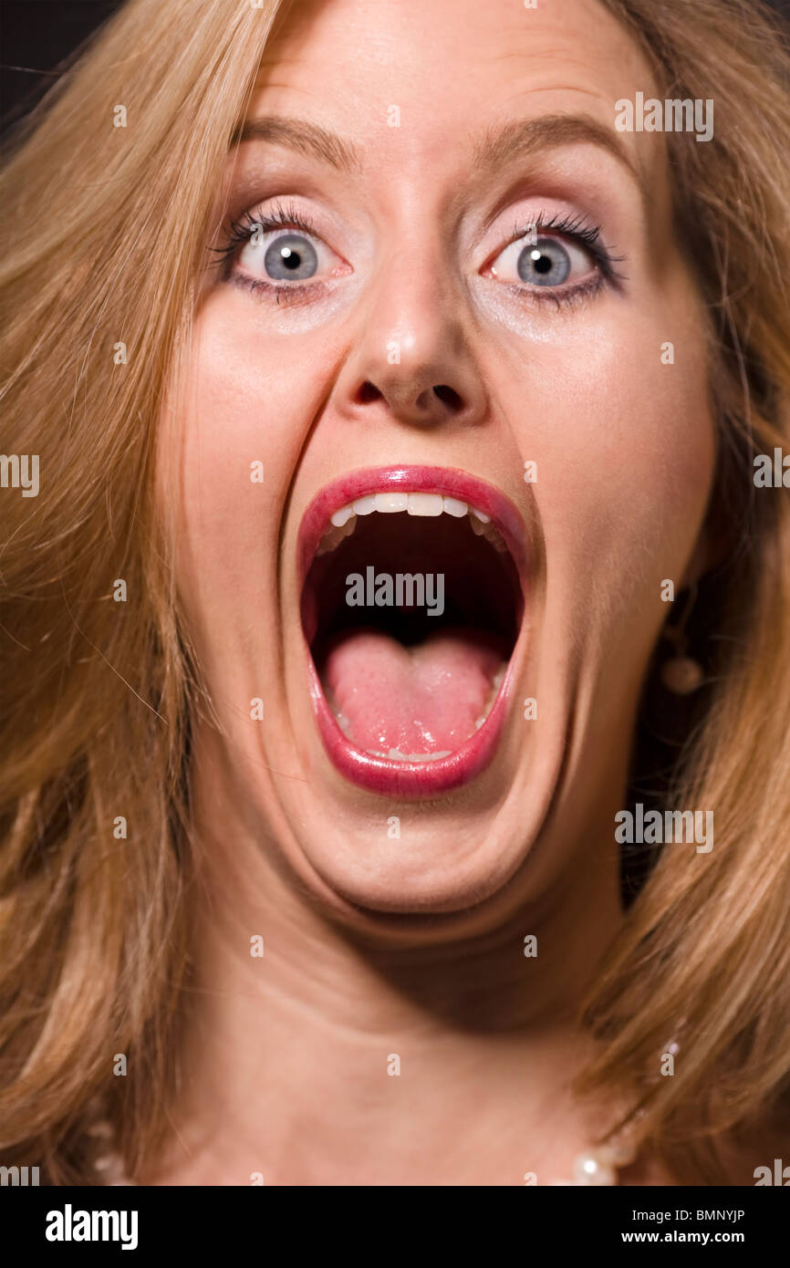 Portrait of a gleeful blonde woman with silly facial expression Stock Photo