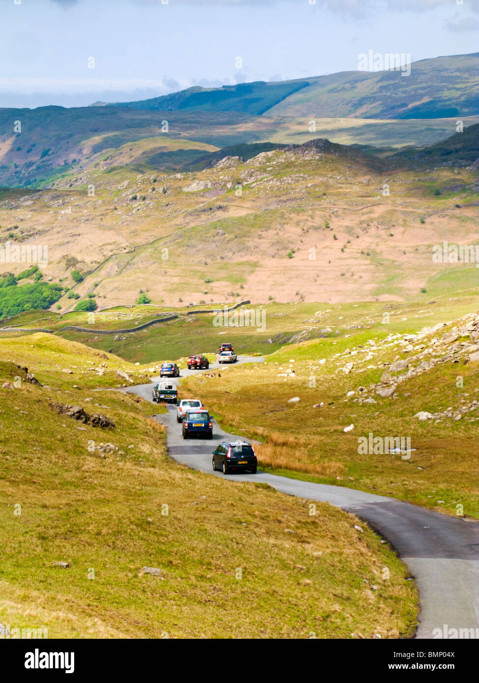Cars driving over Hardknott Pass towards the Roman Fort in The Lake District,  Cumbria, England, UK Stock Photo