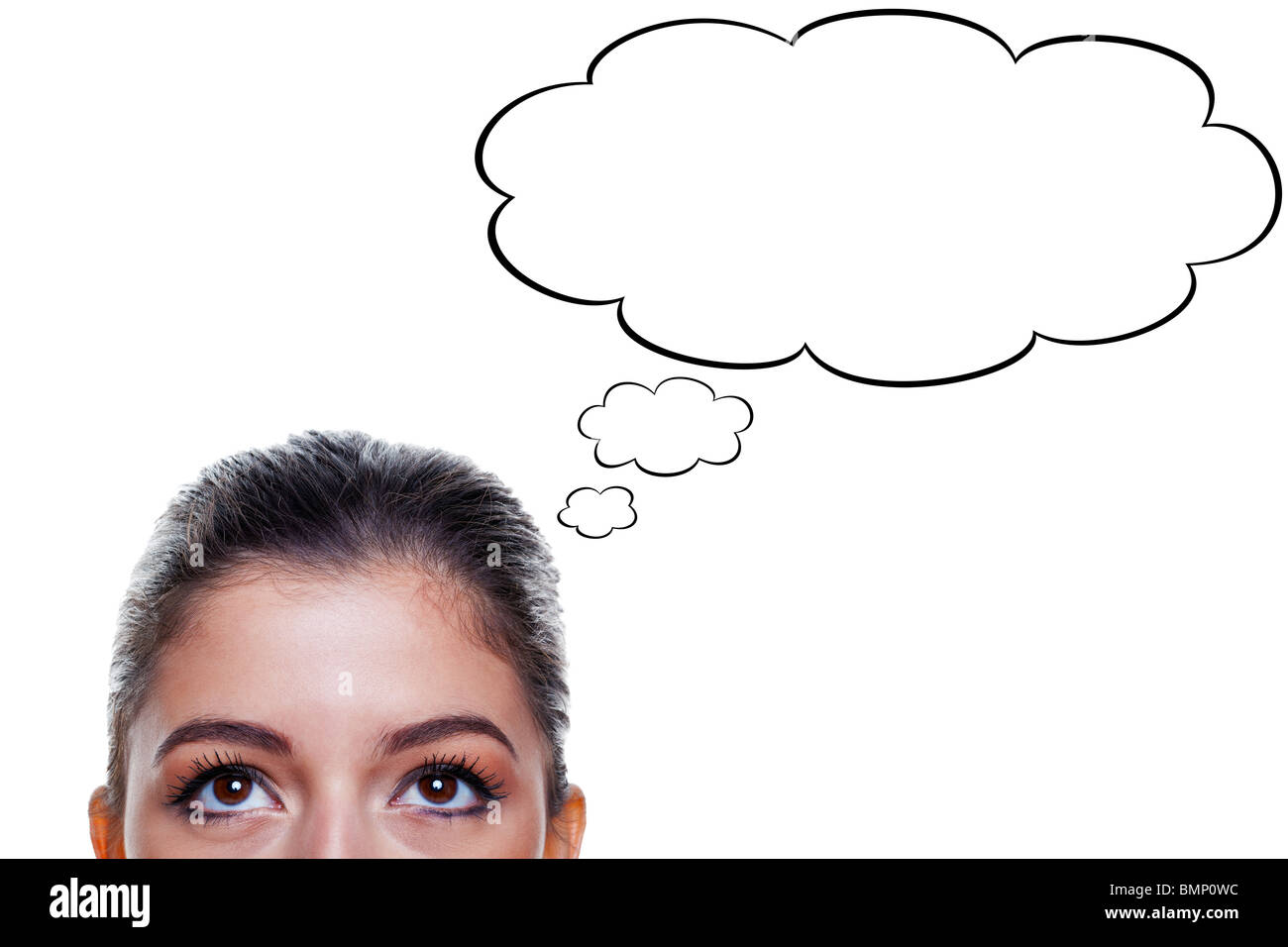 Brunette woman with big brown eyes looking upwards with thought bubbles above her head, isolated on white background. Stock Photo